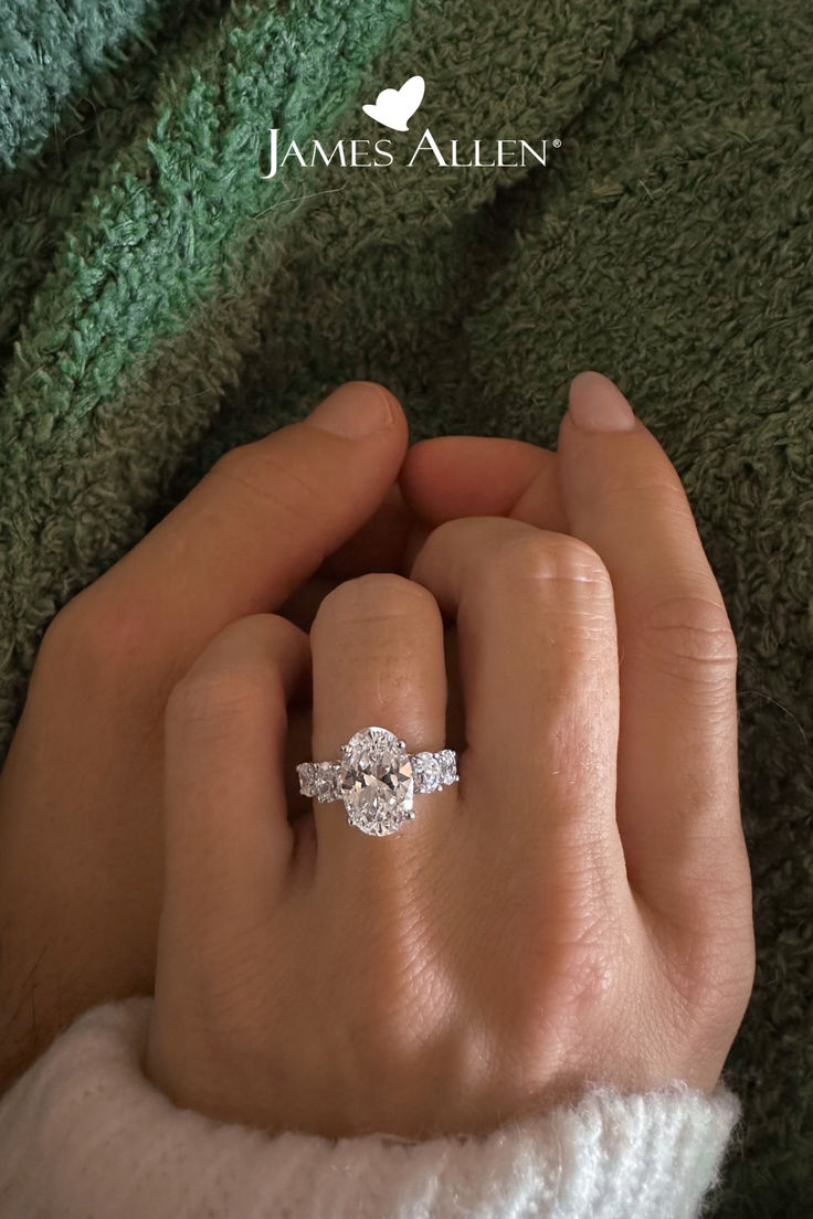 a woman's hand with a diamond ring on it