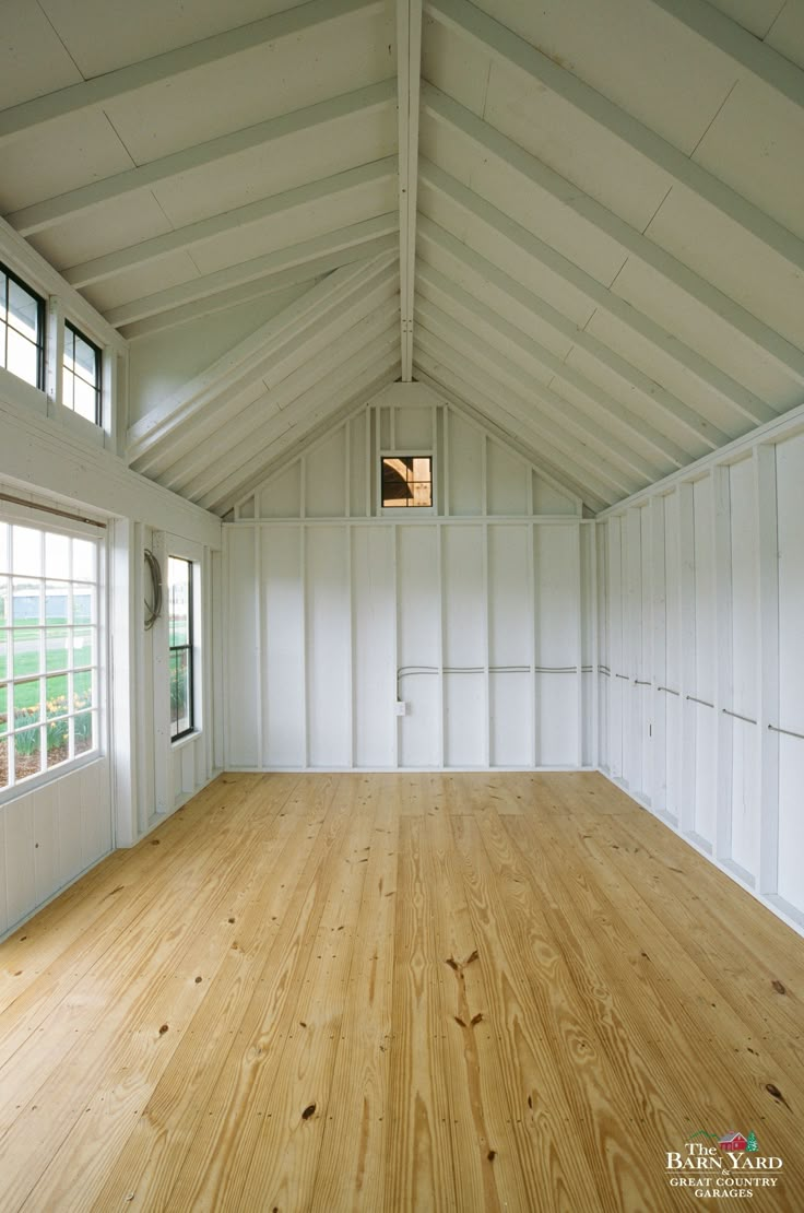 an empty room with white walls and wood floors is seen in this image from the inside