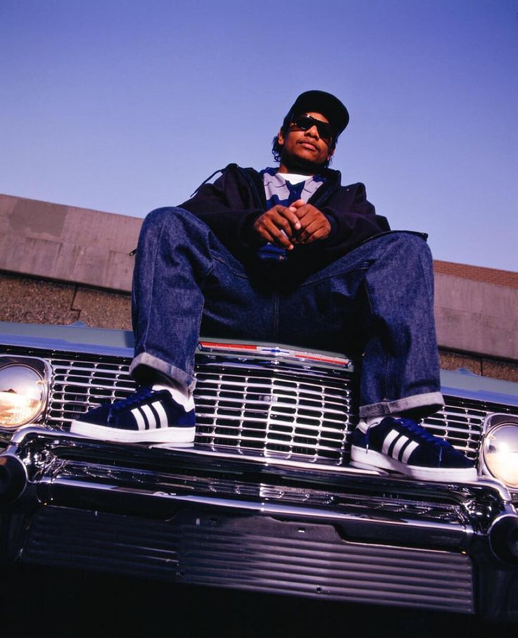 a man sitting on the hood of a car