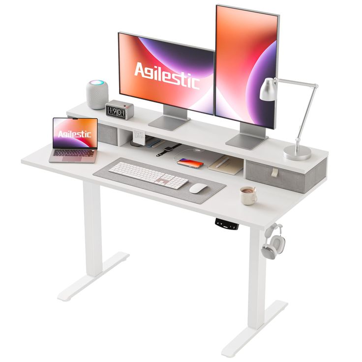 two computer monitors sitting on top of a white desk