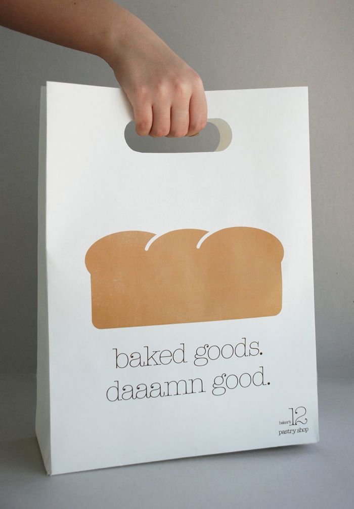 a person is holding a bag with bread on it that says baked goods damn good