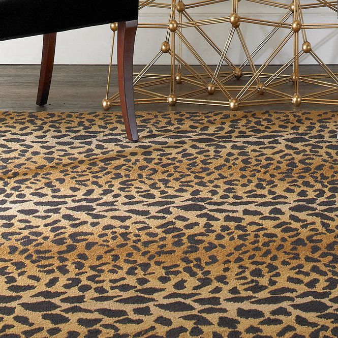 an animal print rug with a chair in the background