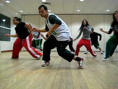 a group of young men and women dancing in a gym