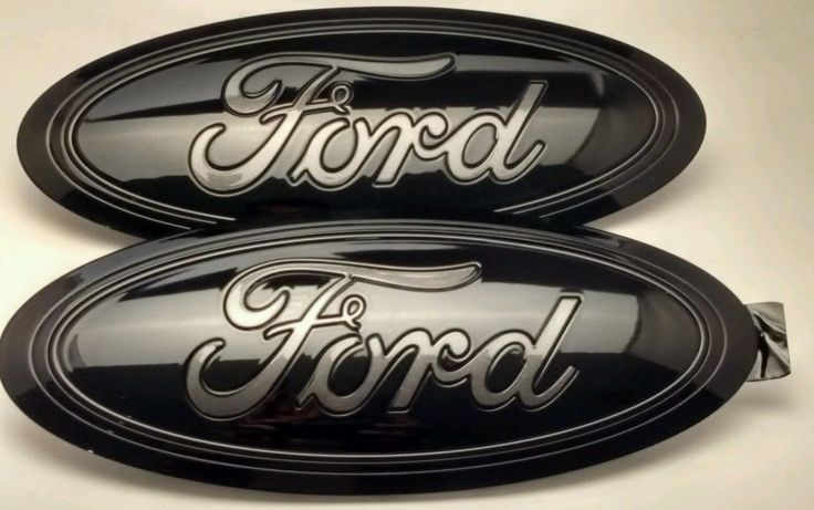 two black ford oval emblems with the word ford on them