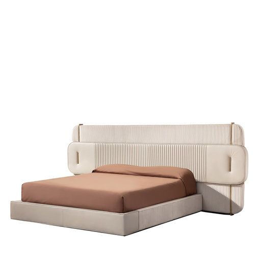 a bed that is sitting next to a white wall