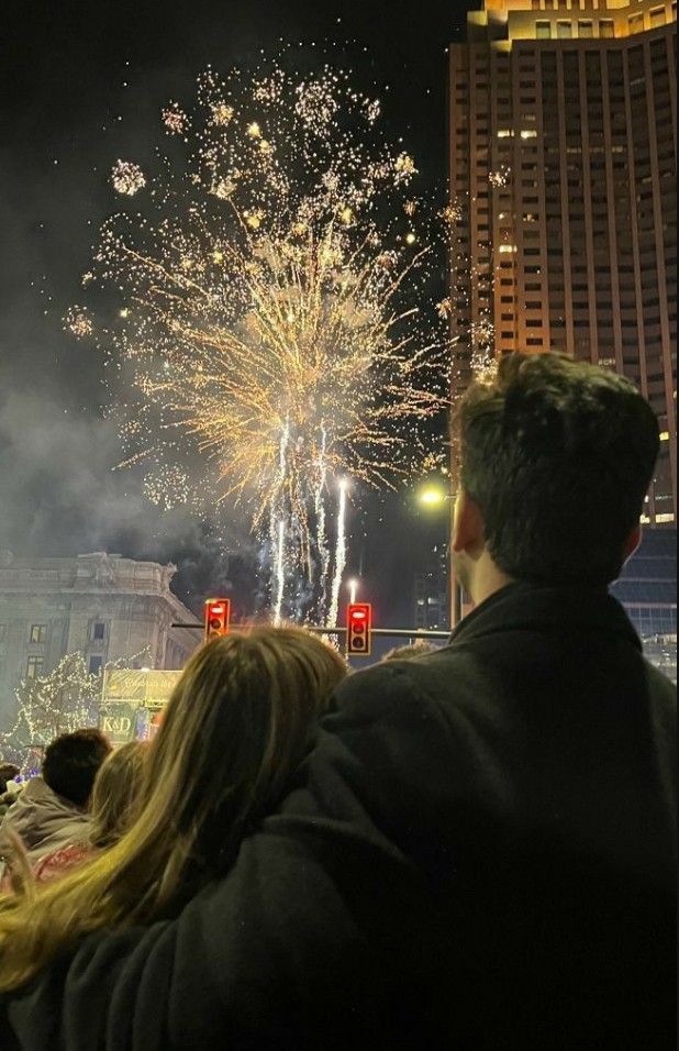 people are watching fireworks in the night sky