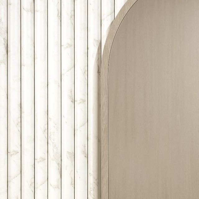 an arched wooden door in front of a marble wall