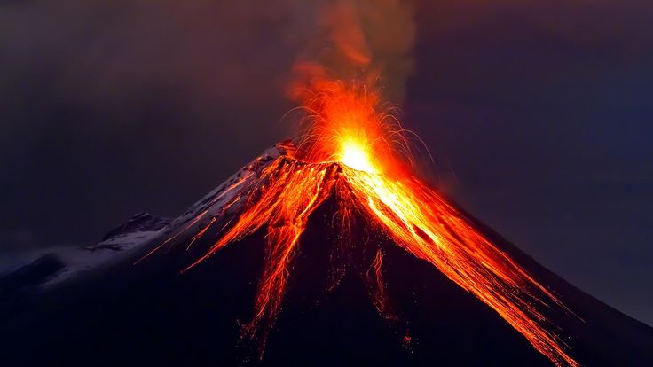 a volcano erupts lava as it rises into the night sky with bright red and orange lights