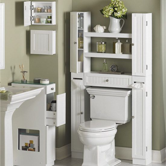 a white toilet sitting in a bathroom next to a sink and cabinet filled with items