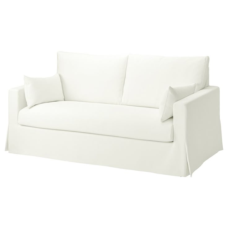 a white couch with two pillows on it