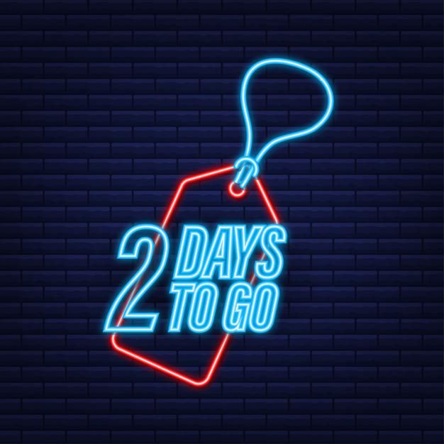 two days to go neon sign on brick wall background with hanging tag and keychain