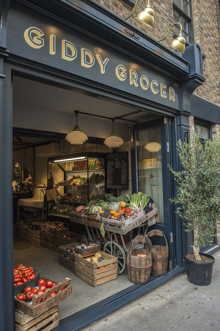 a store front with various fruits and vegetables in the window