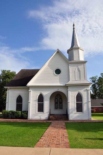 a white church with a steeple on the front