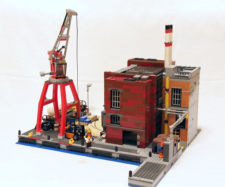 a lego model of a building with a crane on it's side and a fire hydrant next to it