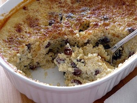 a close up of a casserole dish on a table with a spoon in it