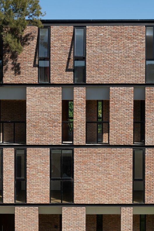 a tall brick building with lots of windows