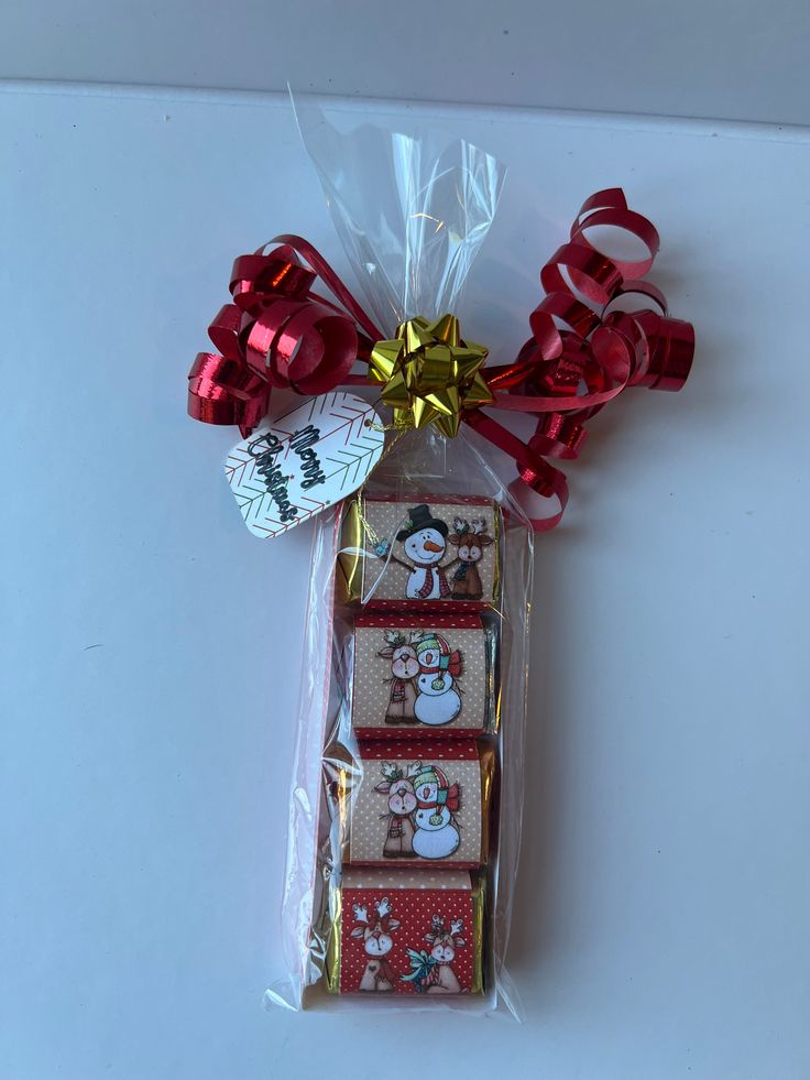 a package of christmas crackers wrapped in cellophane with bows and snowmen on them