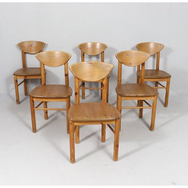 six wooden chairs are arranged in a row