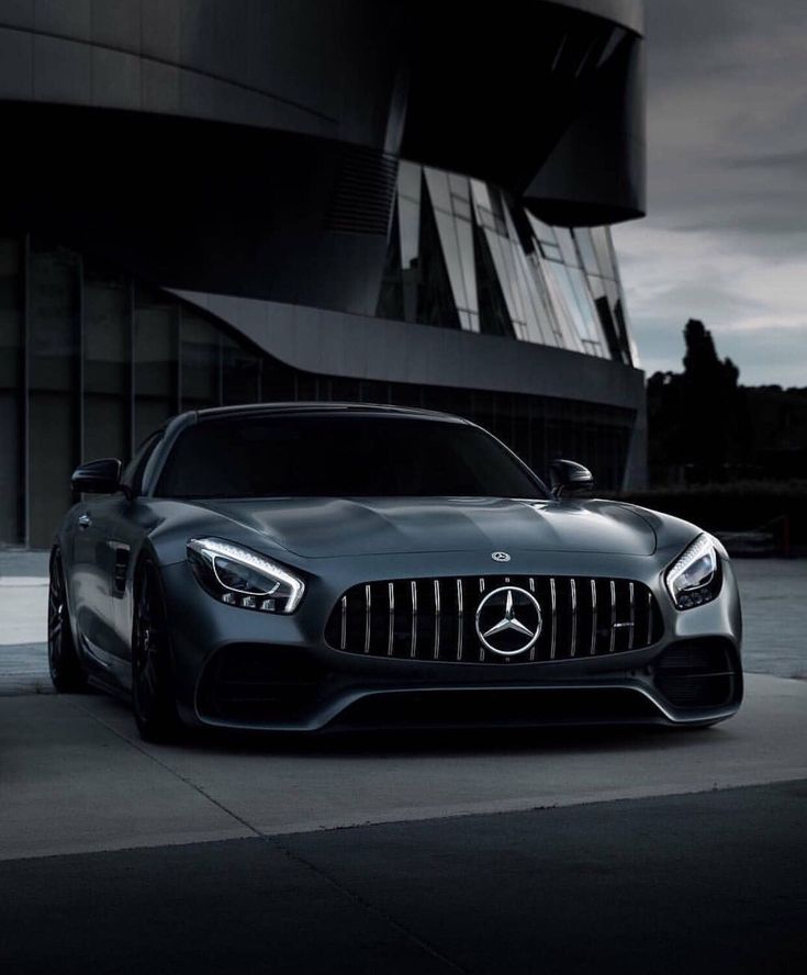 a mercedes sports car parked in front of a building