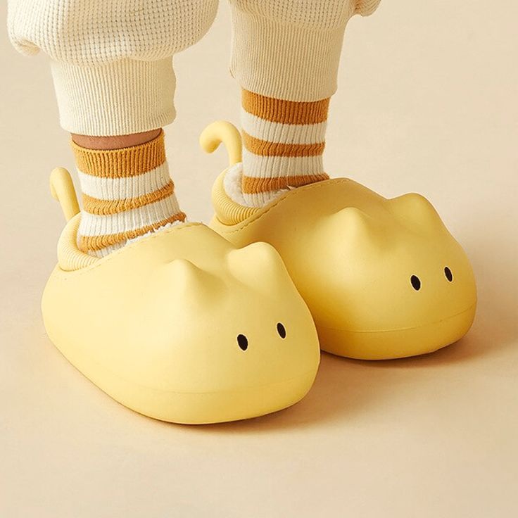 a person in white socks and yellow shoes with their feet up on a rubber shoe