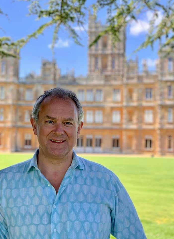 a man standing in front of a large building