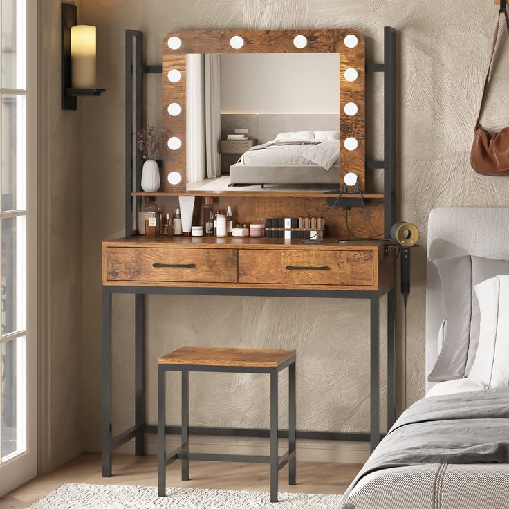 a bedroom with a vanity, mirror and stool next to a window that has lights on it