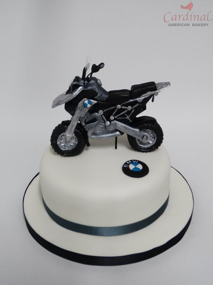 a white cake with a motorcycle on top