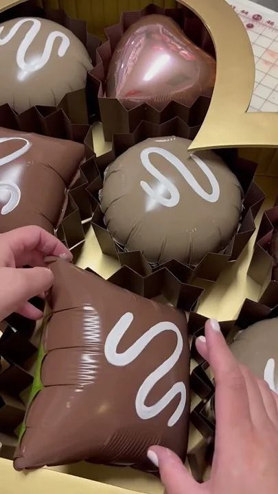 chocolates in a box with the number 90 on them being handed out to someone