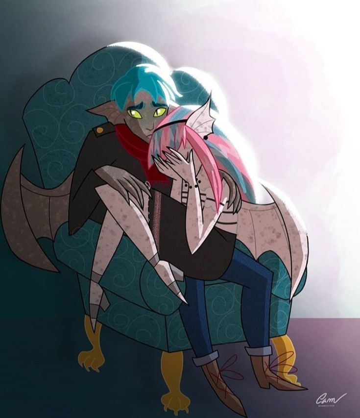 two people sitting on a couch with their arms around each other, one holding the other