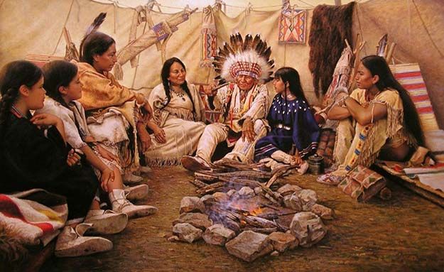 an image of native americans sitting around a campfire