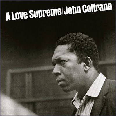 a black and white photo of a man in front of a sign that says, a love supreme john colt