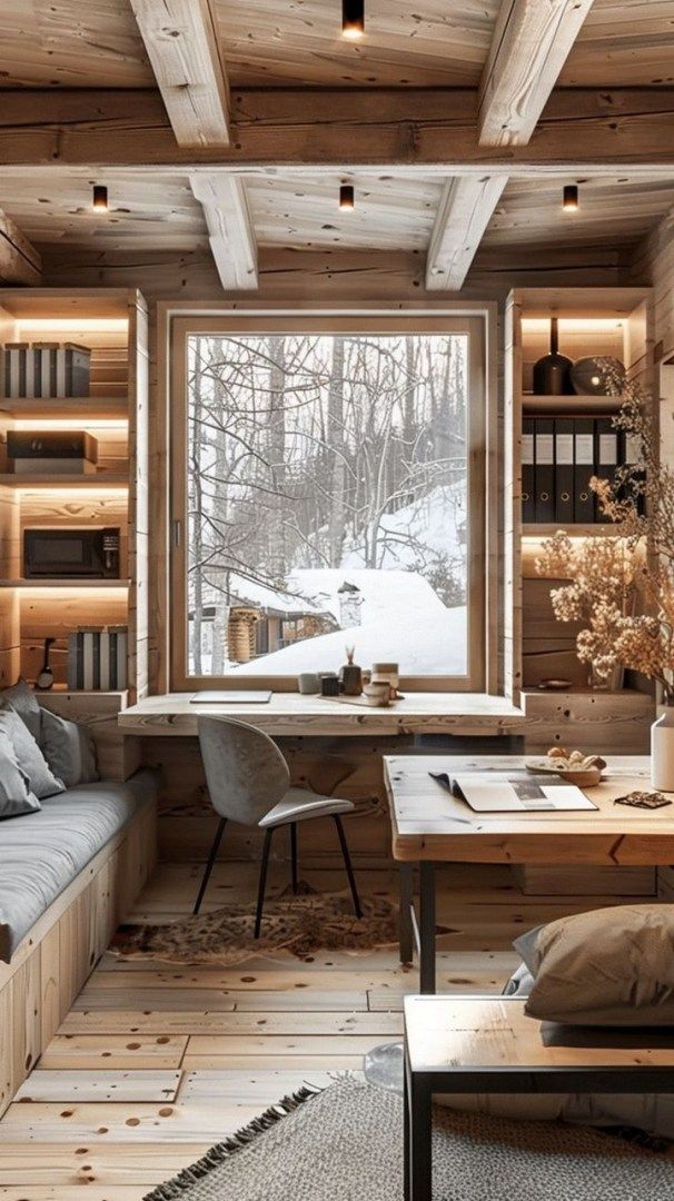 a living room filled with lots of furniture and bookshelves next to a window