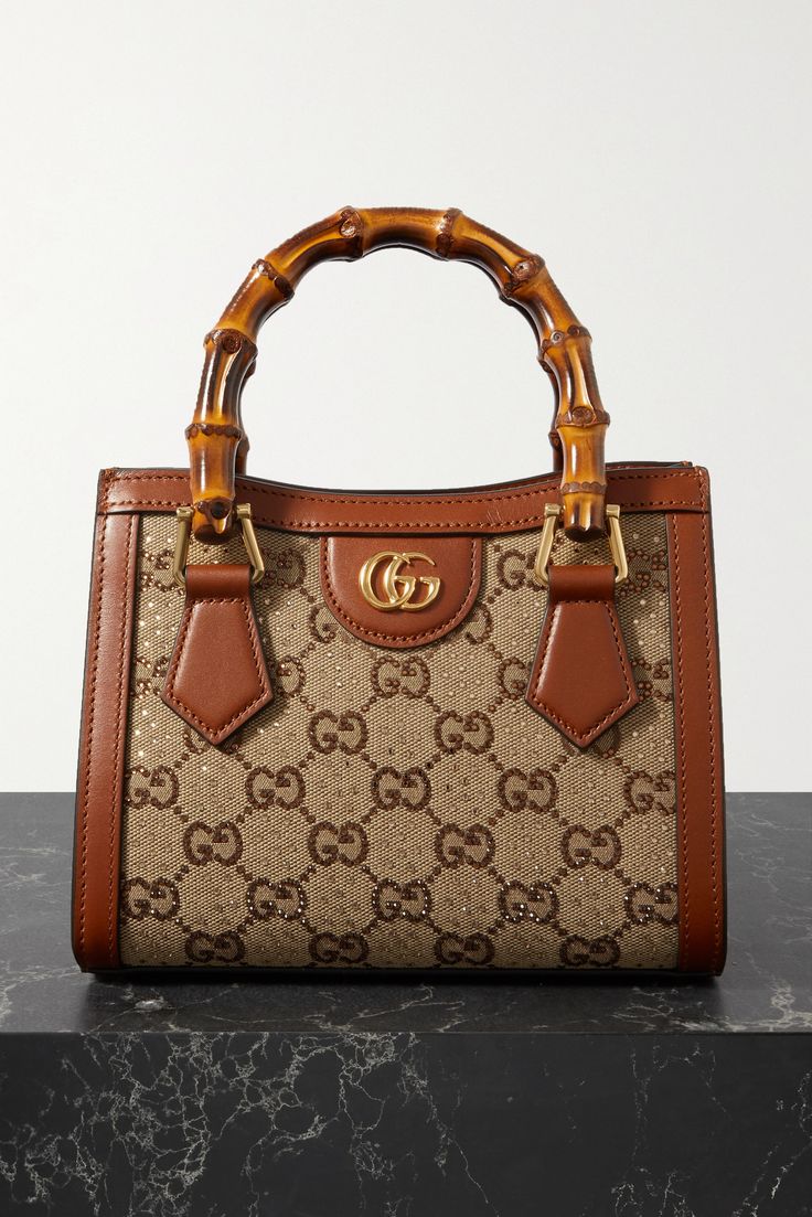 Gucci's 'Diana' bag is part of the 'Love Parade' collection, which revives Old-Hollywood glamor. Crafted in Italy, it's made from canvas-jacquard that's detailed with crystal-dusted 'GG' motifs and trimmed with leather. The bamboo top handles have been a brand signature since the '40s. Attach the shoulder strap to go hands-free. Hand Bag Gucci, Luxury Purses Gucci Bags, Gucci Bamboo Bag, Gucci Bags Handbags, Gucci Diana, Gucci Products, Hollywood Glamor, Multi Colored Bag, Luxury Bags Collection