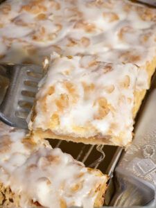 some food is sitting on top of a metal tray with a fork and spoon in it