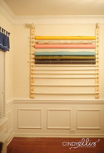 a room with several different colored fabrics hanging on the wall