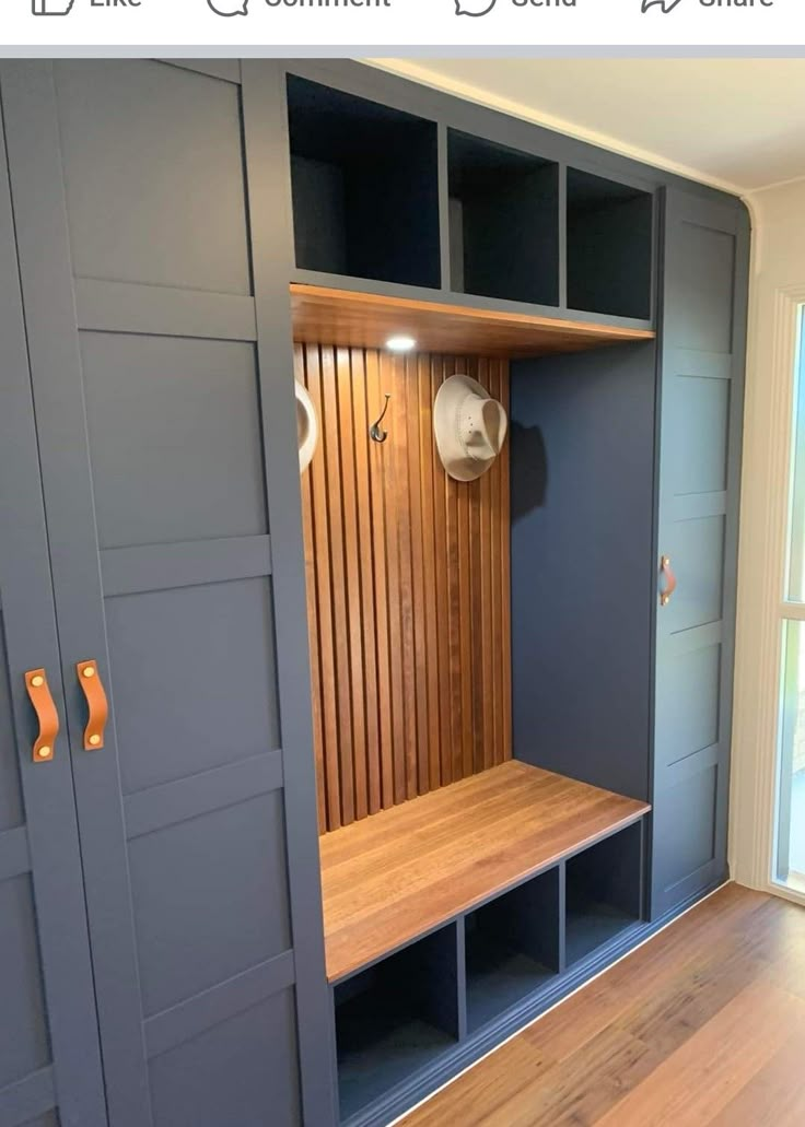 a wooden bench sitting in the middle of a room next to some cupboards and shelves