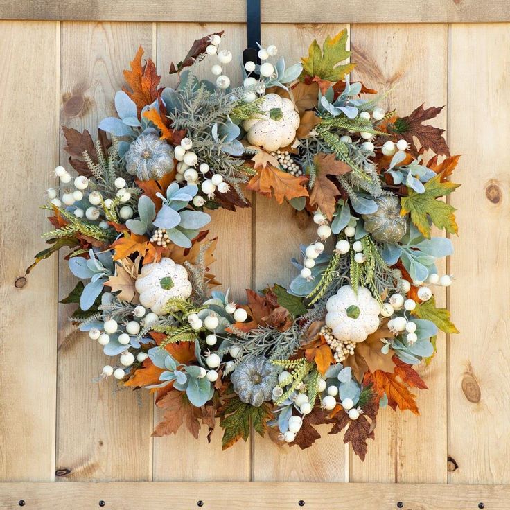 a wreath is hanging on a wooden wall