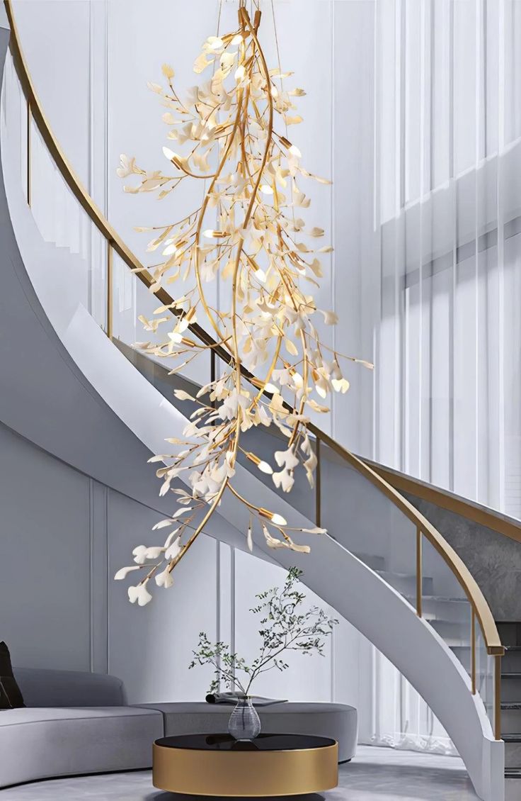 a modern living room with a spiral staircase and chandelier hanging from the ceiling