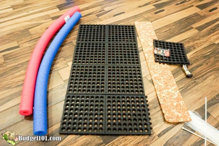 the flooring is being laid out on top of the wooden floor with plastic pipes