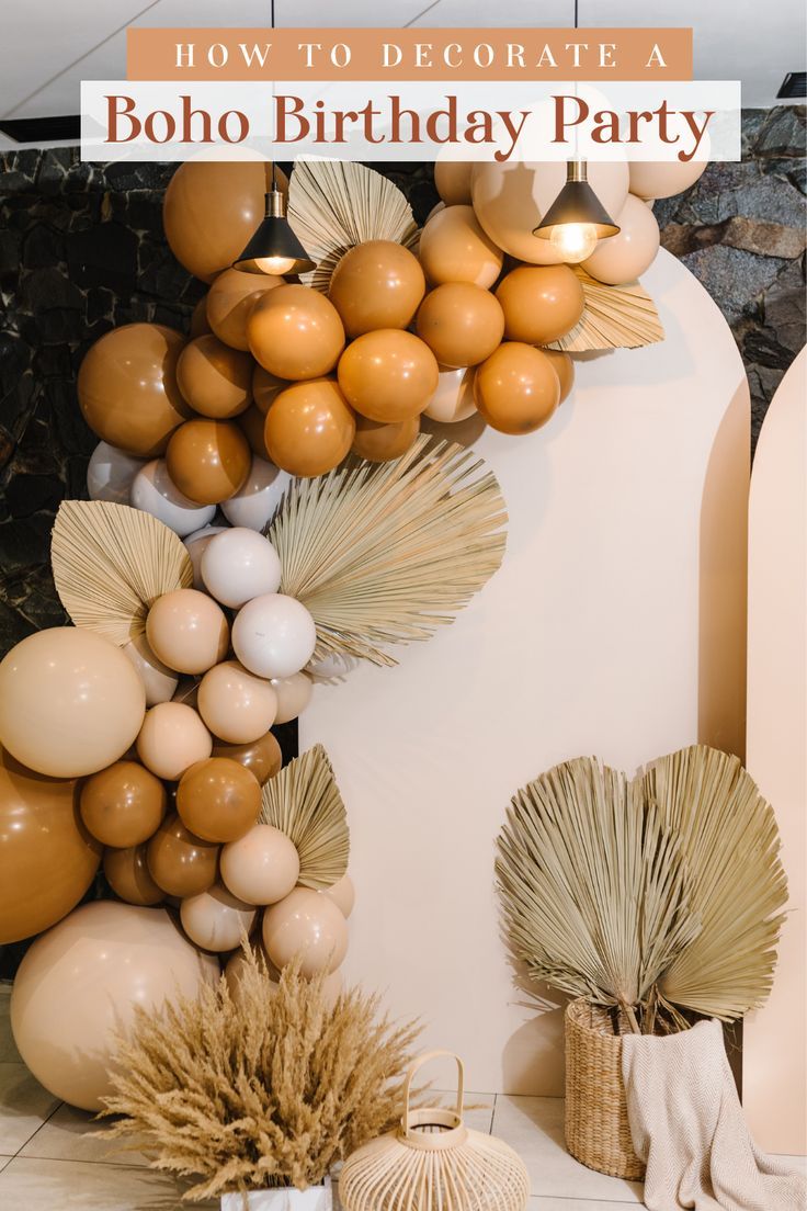 a birthday party with balloons, palm leaves and other decorations on the wall behind it