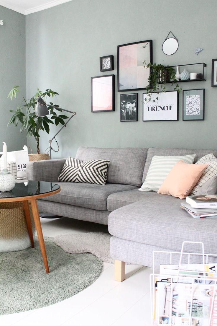 a living room filled with lots of furniture and pictures on the wall above it's coffee table