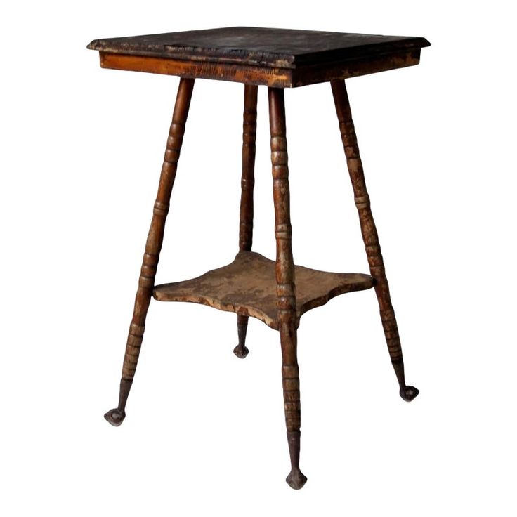 an old wooden table with two legs and a shelf on the top that is turned upside down