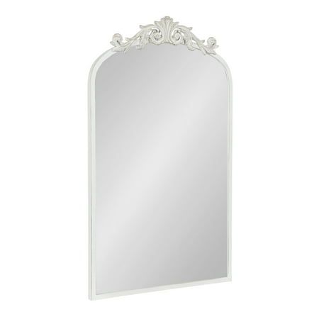 an ornate white mirror on a white wall