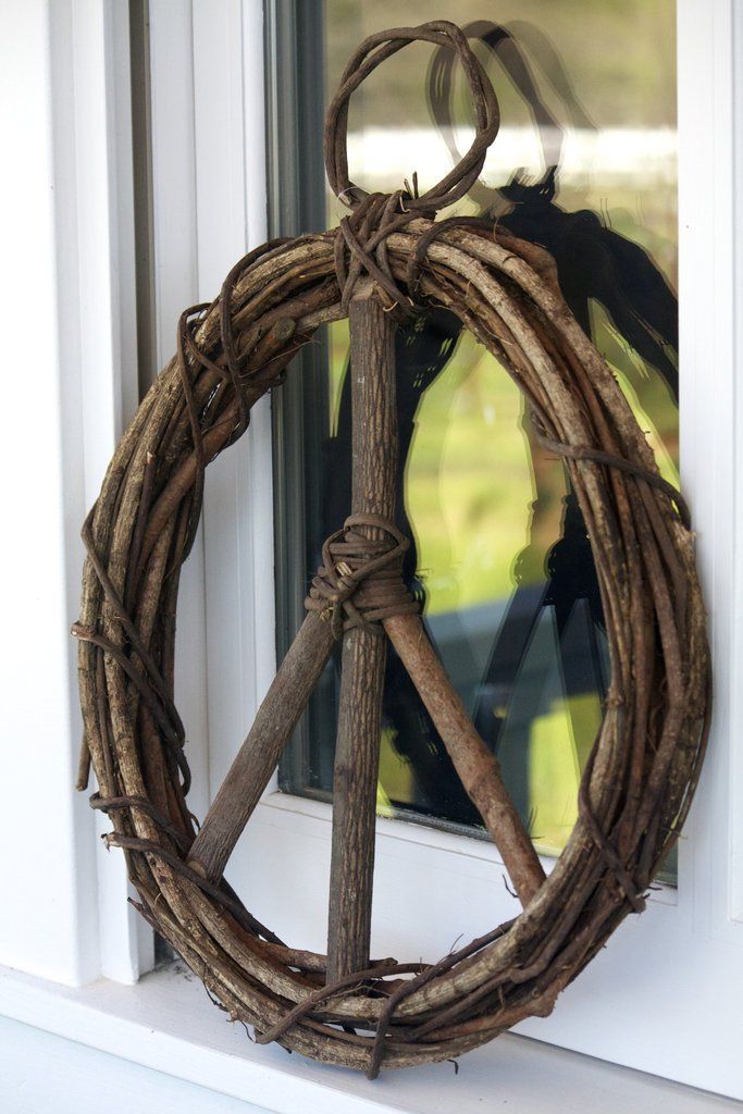 a peace sign made out of branches on a window sill