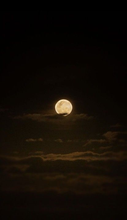 the moon is shining brightly in the dark night sky above some clouds, and it appears to be just overcast