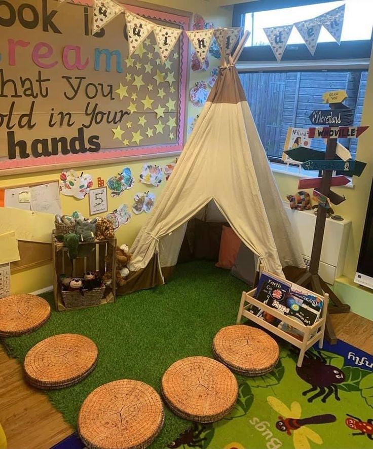 a child's playroom with lots of toys and decorations on the floor, including a teepee tent