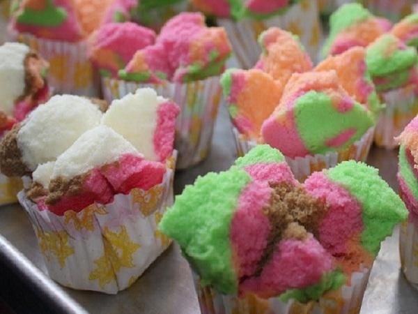 cupcakes with colorful frosting and sprinkles are on a tray