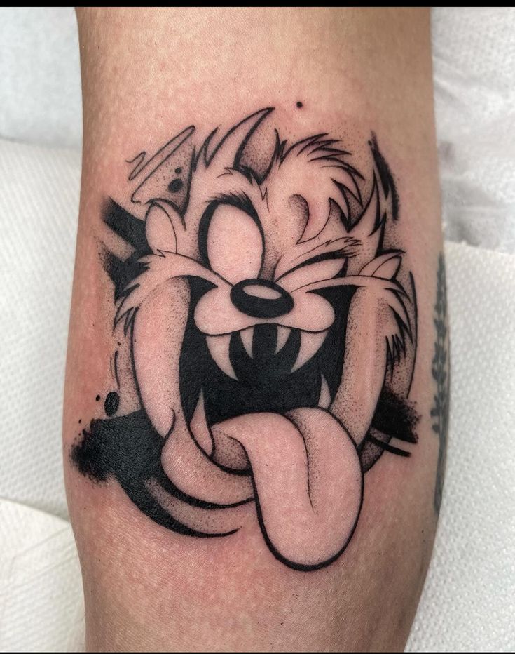 a cartoon character tattoo on the leg