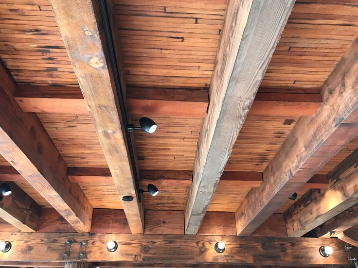 the ceiling is covered with wooden beams and lights