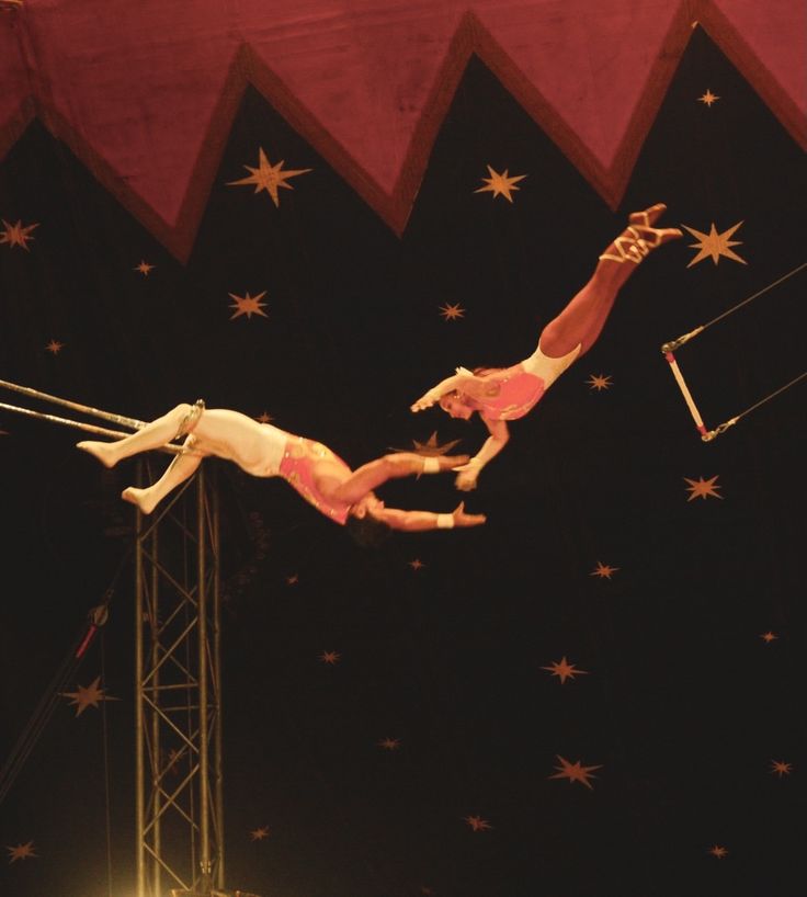 two men performing acrobatic tricks in the air